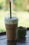 Cold cocoa and cactus placed on a wooden balcony