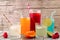 Cold colorful summer drinks against wood