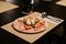 Cold Cuts Burratina: Burrata Cheese served with Parma Ham, Mortadella and Salad. Served in white plate on paper mat