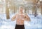 Cold exposure training concept. Joyful senior guy tempering his body with snow at frosty winter forest