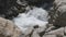 Cold and fast mountain river passing around rock and making white foam swirls. Hinterrhein River, Viamala Gorge, Viamala-Schlucht