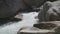 Cold and fast mountain river passing around rock and making white foam swirls. Hinterrhein River, Viamala Gorge, Viamala-Schlucht