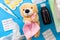 Cold and flu treatment and pediatrics medicine concept with a teddy bear holding a blanket surrounded by  a thermometer, bottle of