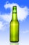 Cold frosted beer bottle with frost bubbles in green glass bottle blue sky