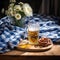 Cold full beer mug with Beirian pretzels on the wooden table covered with traditional blue and white tablecloth during Oktoberfest