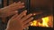 Cold Hands - Woman Rubbing Hands By Fireplace Getting Warm and Cozy In Winter