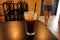 Cold iced black coffee in brown and black trendy casual cafe coffee shop with black decoration interiors