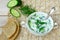 Cold kefir soup with cucumber, herbs, and garlic in white bowl