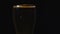 Cold light beer in a glass over black background. Craft Beer close up. Pint of beer.