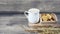 Cold milk in a white tiled glass with biscuits as an afternoon snack