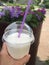 Cold milkshake with straw on summer terrace in cafe