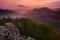 Cold misty foggy morning with twilight sunrise in a fall valley of Bohemian Switzerland park. Hills with fog, landscape of Czech