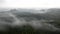 Cold misty night in a fall valley of Saxony Switzerland park. Hills increased from misty darkness.