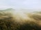 Cold misty night in a fall valley of Saxony Switzerland park. Hills increased from misty darkness.