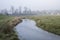 Cold misty Winter landscape over stream in English countryside