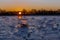 A cold morning with a beautiful warm sunrise in the Eijsder Beemden near Maastricht over a frozen lake with amazing reflections an