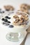 Cold parfait dessert with creamy yogurt, crumbled chocolate chip cookies and blueberries.