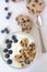 Cold parfait dessert with creamy yogurt, crumbled chocolate chip cookies and blueberries.