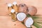 Cold pressed extra virgin coconut oil in bottles with coconuts