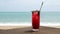 Cold Red Mocktail With Berries on Beach Table, Defocused Sea Waves on Background