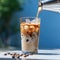 Cold refreshing coffee with ice in a tall glass on a wooden board close-up, cocoa beans are scattered on the table, Blue