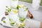 Cold refreshing mojito with lime and mint in tall glasses