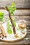 Cold refreshing Moroccan tea with cinnamon and mint in a tall decanter on a simple wooden background with a brown sugar