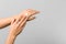 Cold season hands skin protection. closeup woman applying protective cream on hands