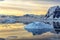 Cold still water of antarctic lagoon with drifting blue icebergs