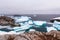 Cold still waters of antarctic sea lagoon with drifting blue ice