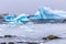 Cold still waters of antarctic sea lagoon with drifting blue ice