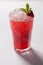 Cold straw red drink with berry and mint leaf.