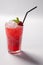 Cold straw red drink with berry and mint leaf.