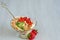 Cold summer dessert with sliced strawberries, whipped cream in the glass bowl on the gray kitchen background with copy space