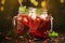 Cold summer red tea with ice, lime and mint, refreshing soft drink in jars, dark table background, selective focus