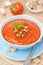 Cold tomato soup gazpacho with basil in a bowl top view