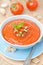 Cold tomato soup gazpacho with basil in a bowl top view vertical