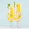Cold tropical oranges juice in misted wineglass with sliced fruit, mint, ice cubes on pastel soft blue background, square.
