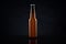 Cold unopened bottle of beer with cap on black background. Glass of refrigerated wheat or lager beer on dark background