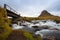 Cold water in Iceland. Waterfall in rocky mountains. Fresh and g