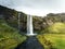 Cold water in Iceland. Waterfall in rocky mountains. Fresh and g