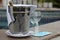 cold wine bottle in aluminum cooler and crystal glasses with protection mask and antibacterial gel, new normal