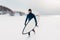 Cold winter and male surfer with surfboard. Snowy weather day with surfer in wetsuit