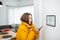 Cold woman controlling heating with a smart devices