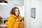 Cold woman controlling heating with a smart devices