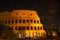 Coliseum at night with multi-colored illumination