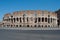 The Coliseum from the outside, Roman architecture with stones. Ancient and historical monument in Europe.