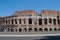 The Coliseum from the outside, Roman architecture with stones. Ancient and historical monument in Europe.