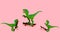 collage of cute green dinosaurs skate isolated on a pink background
