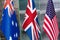 Collage of flags of Australia, the United Kingdom and the United States.